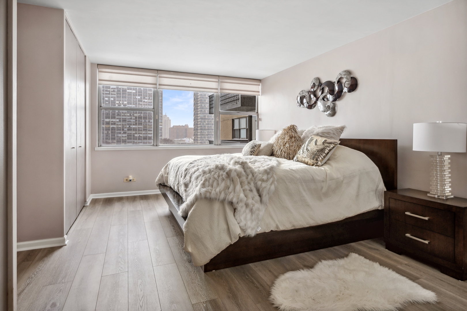 6301 North Sheridan Road, Unit 8E Chicago, IL 60660 - Photo 11 of 19 a bedroom with a bed and a night stand