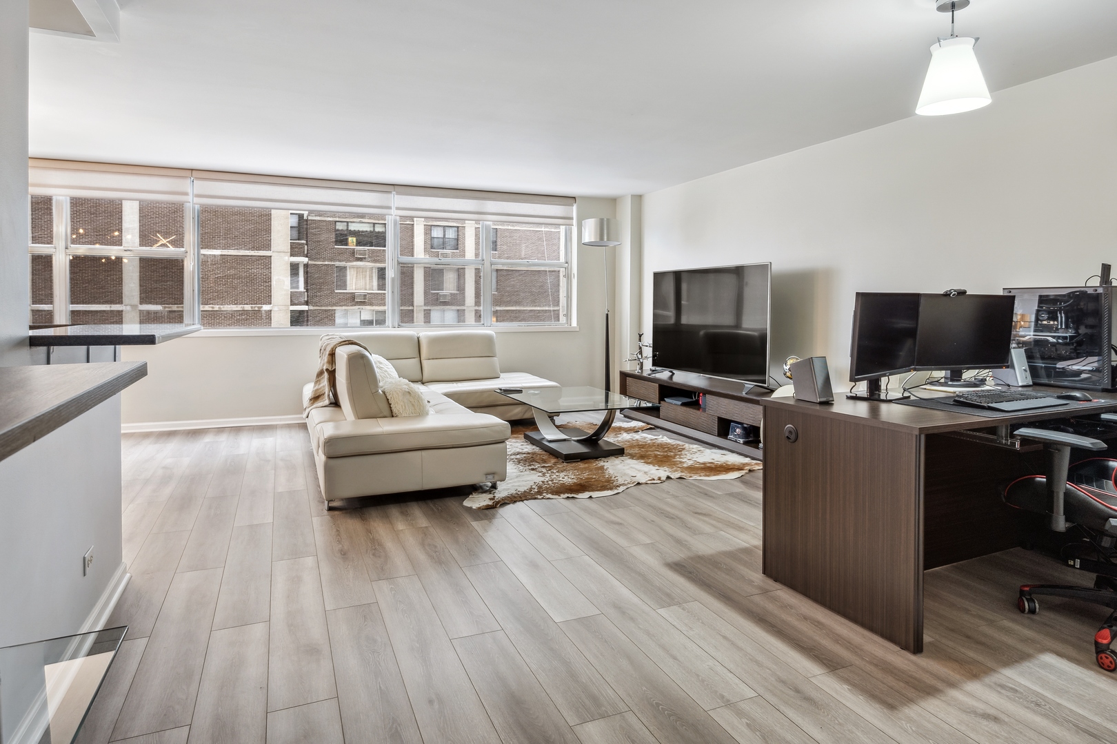 6301 North Sheridan Road, Unit 8E Chicago, IL 60660 - Photo 2 of 19 a living room with furniture and a flat screen tv