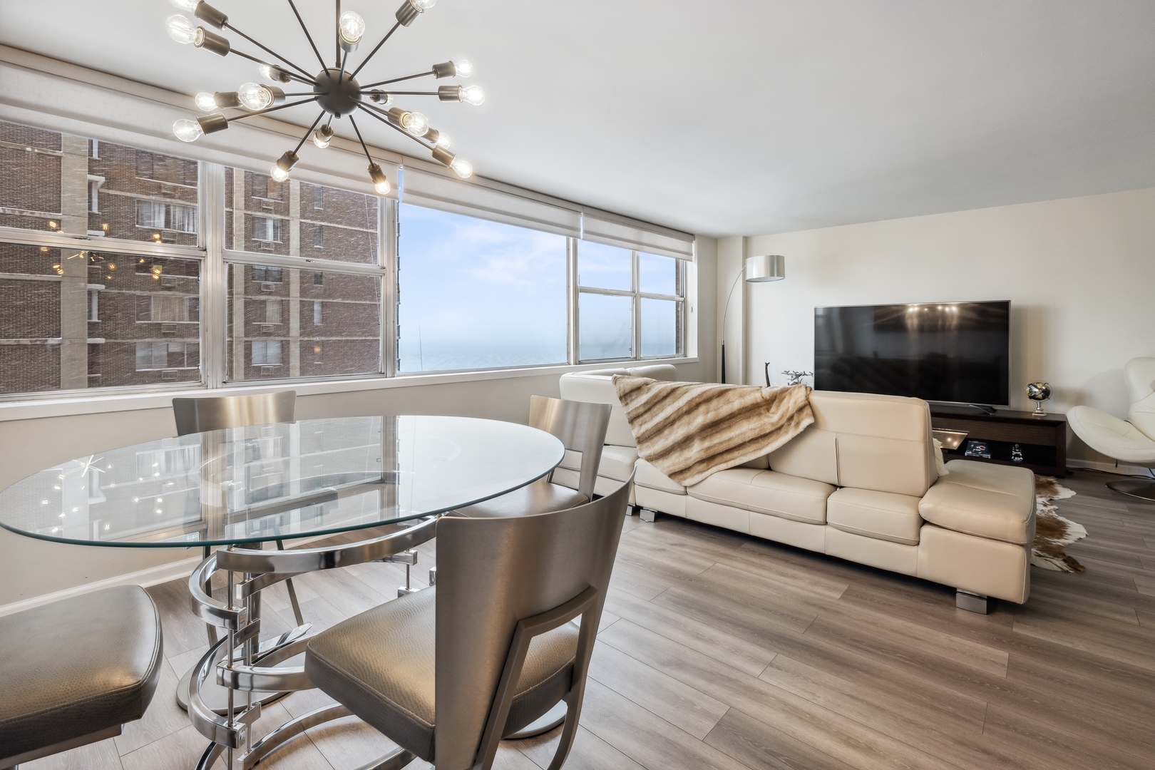 6301 North Sheridan Road, Unit 8E Chicago, IL 60660 - Photo 4 of 19 a living room with furniture and a flat screen tv