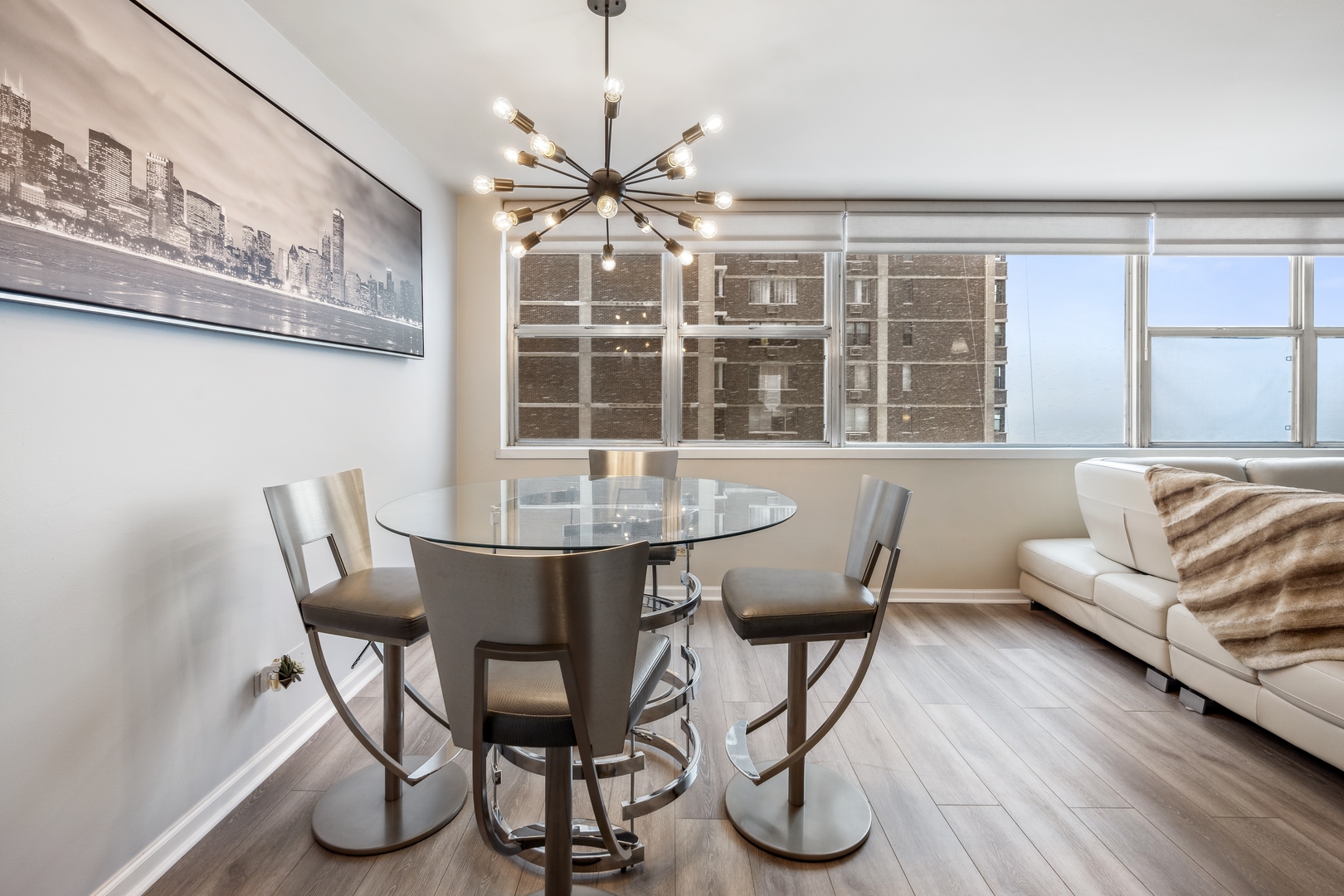 6301 North Sheridan Road, Unit 8E Chicago, IL 60660 - Photo 5 of 19 a view of a dining room with furniture window and wooden floor