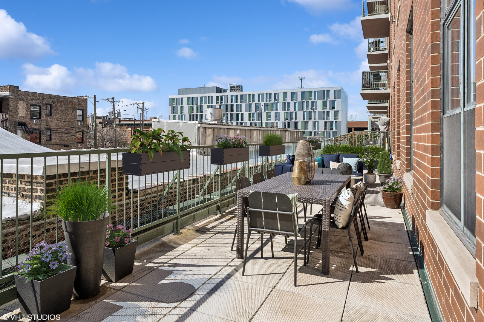 3631 North Halsted Street, Unit 208 Chicago, IL 60613 - Photo 14 of 19 a view of a balcony with a potted plant and city view