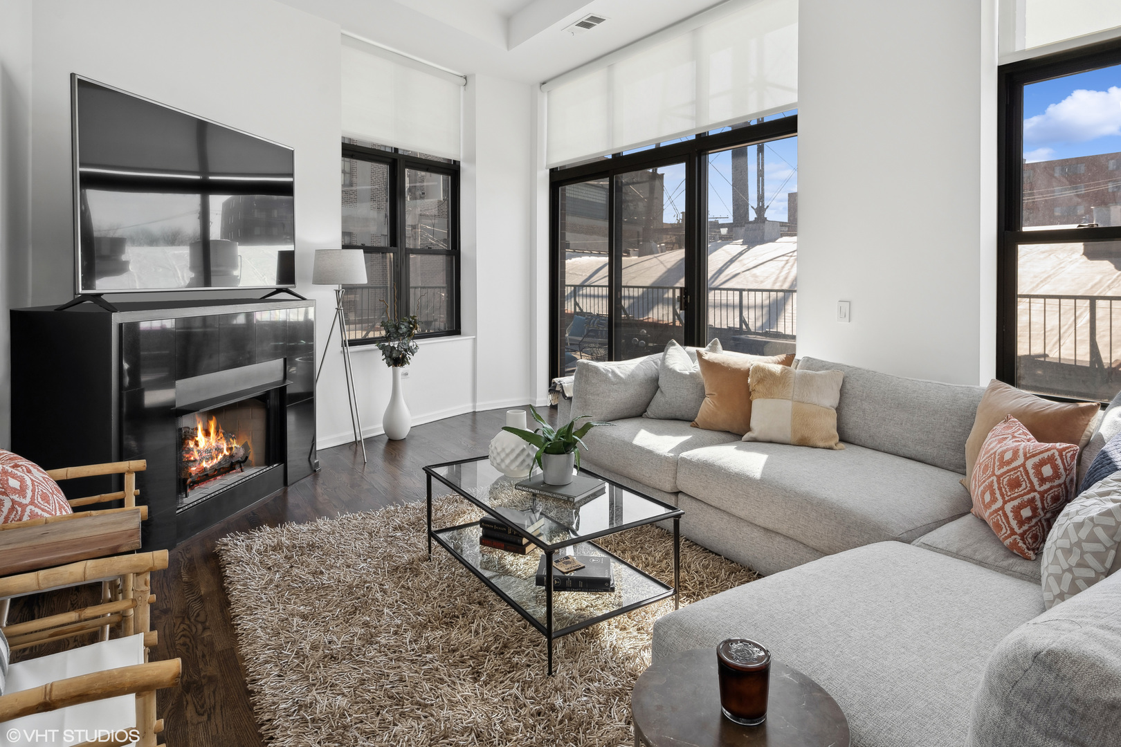 3631 North Halsted Street, Unit 208 Chicago, IL 60613 - Photo 2 of 19 a living room with furniture a flat screen tv and a floor to ceiling window