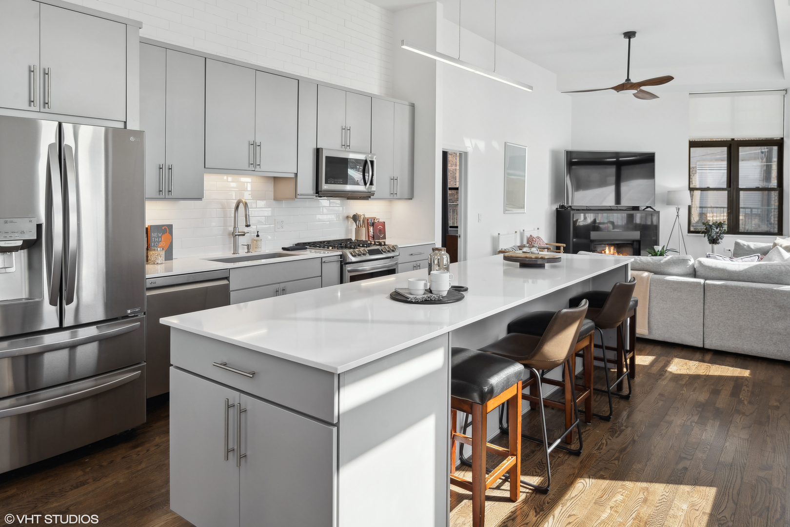 3631 North Halsted Street, Unit 208 Chicago, IL 60613 - Photo 4 of 19 a kitchen with a table chairs refrigerator and microwave