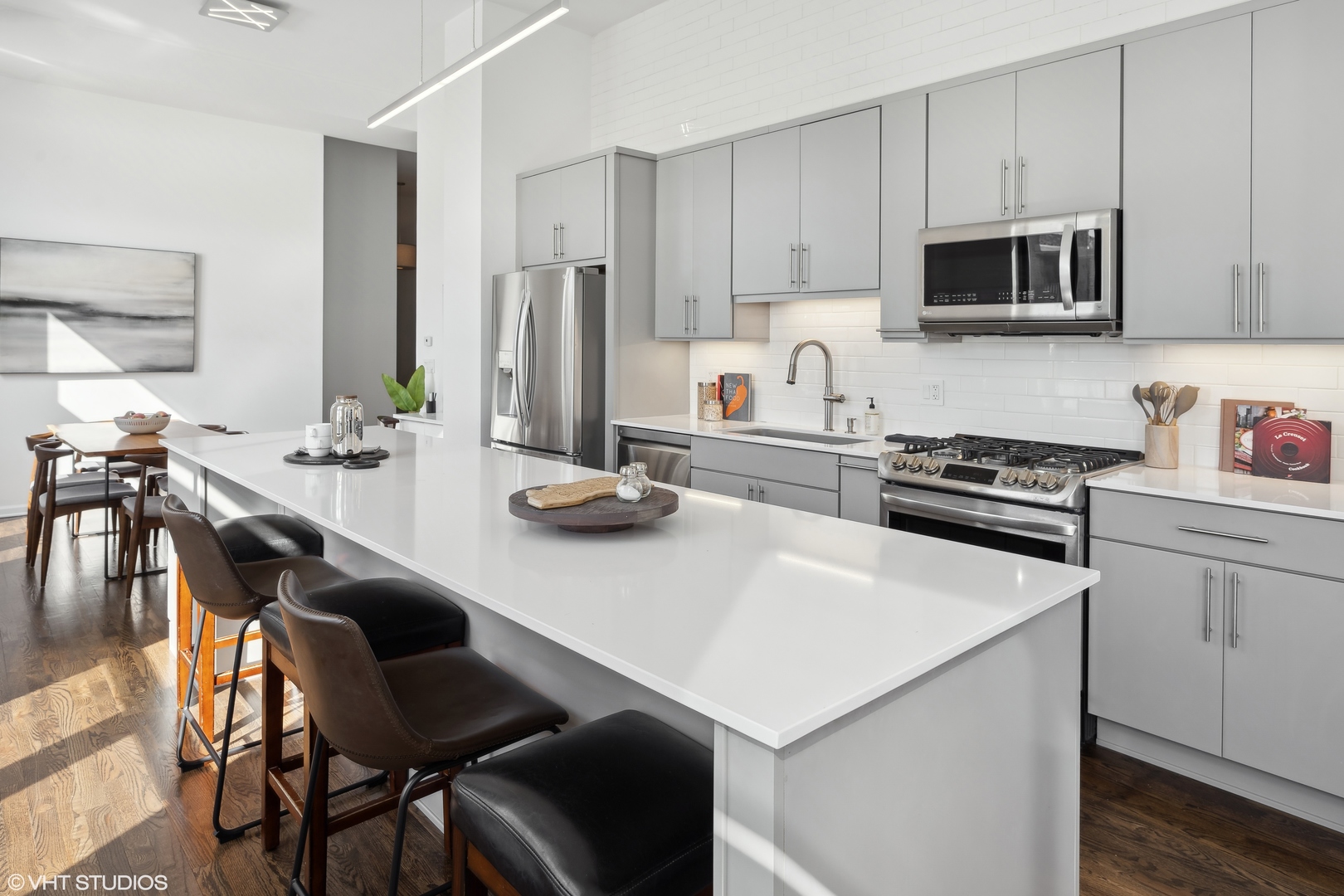 3631 North Halsted Street, Unit 208 Chicago, IL 60613 - Photo 5 of 19 a kitchen with a dining table and chairs