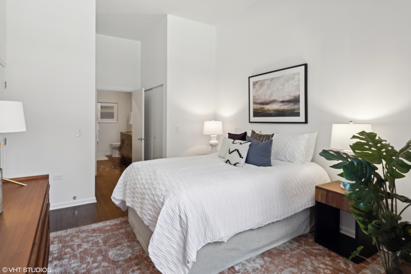 3631 North Halsted Street, Unit 208 Chicago, IL 60613 - Photo 7 of 19 a bedroom with bed and a potted plant