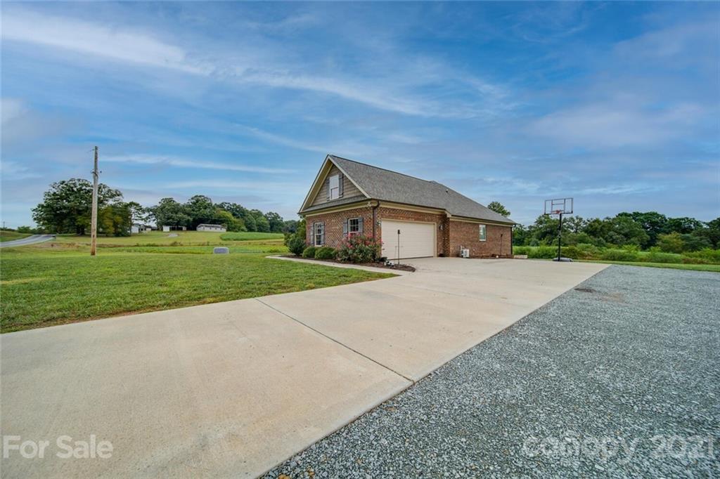 3103 East Brief Road Monroe, NC 28110 - Photo 8 of 41 a front view of a house with a yard and garage