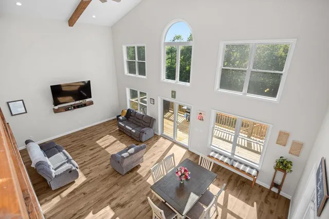 a living room with furniture window and a flat screen tv
