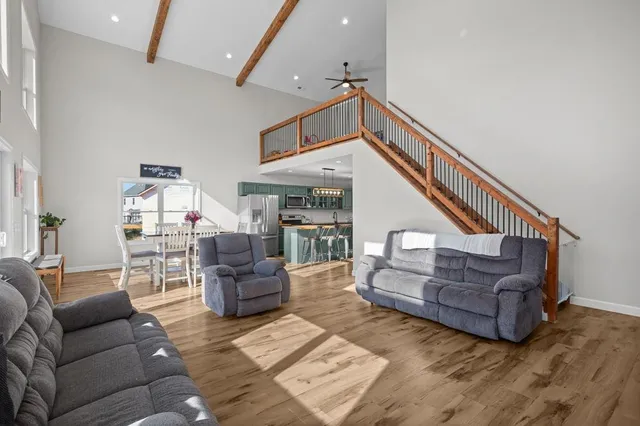 a living room with furniture rug and wooden floor