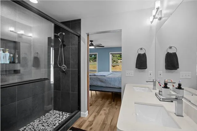 a bedroom with a bed and wooden floor