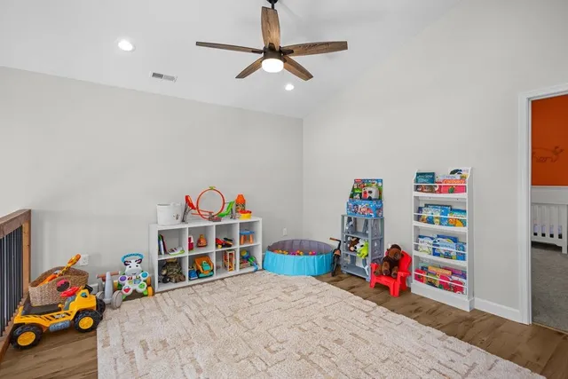a bedroom with furniture and a book shelf
