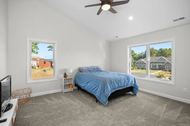 a bedroom with furniture and a book shelf
