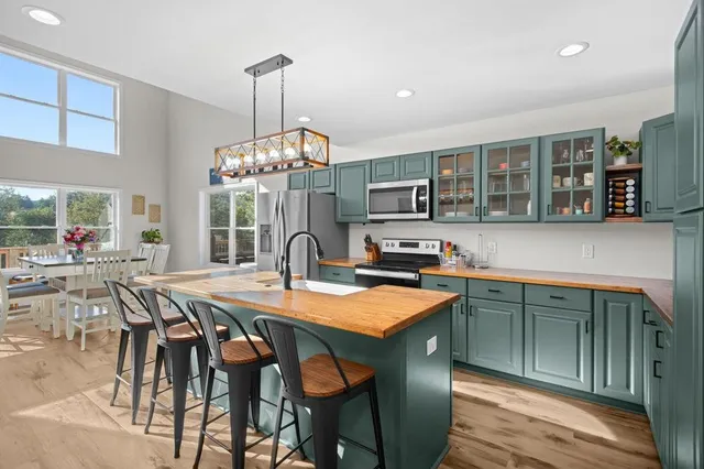 a dining table with chairs and chandelier