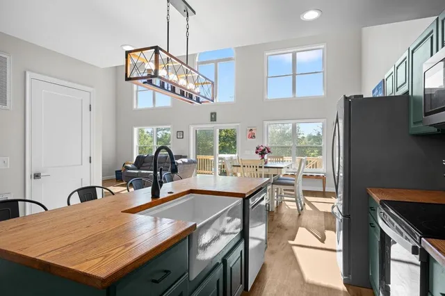 a view of a dining room with furniture and a chandelier
