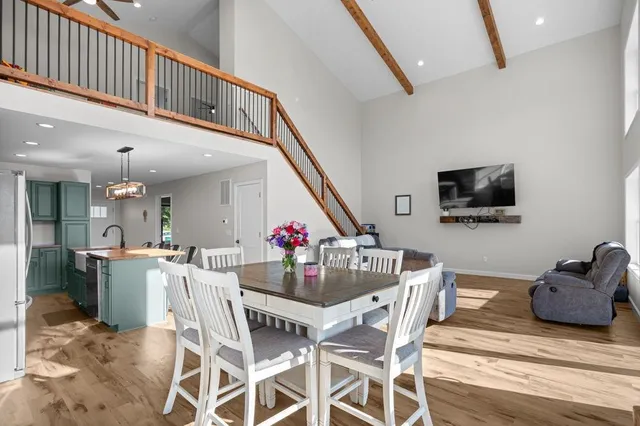 a view of a dining room with furniture and a chandelier