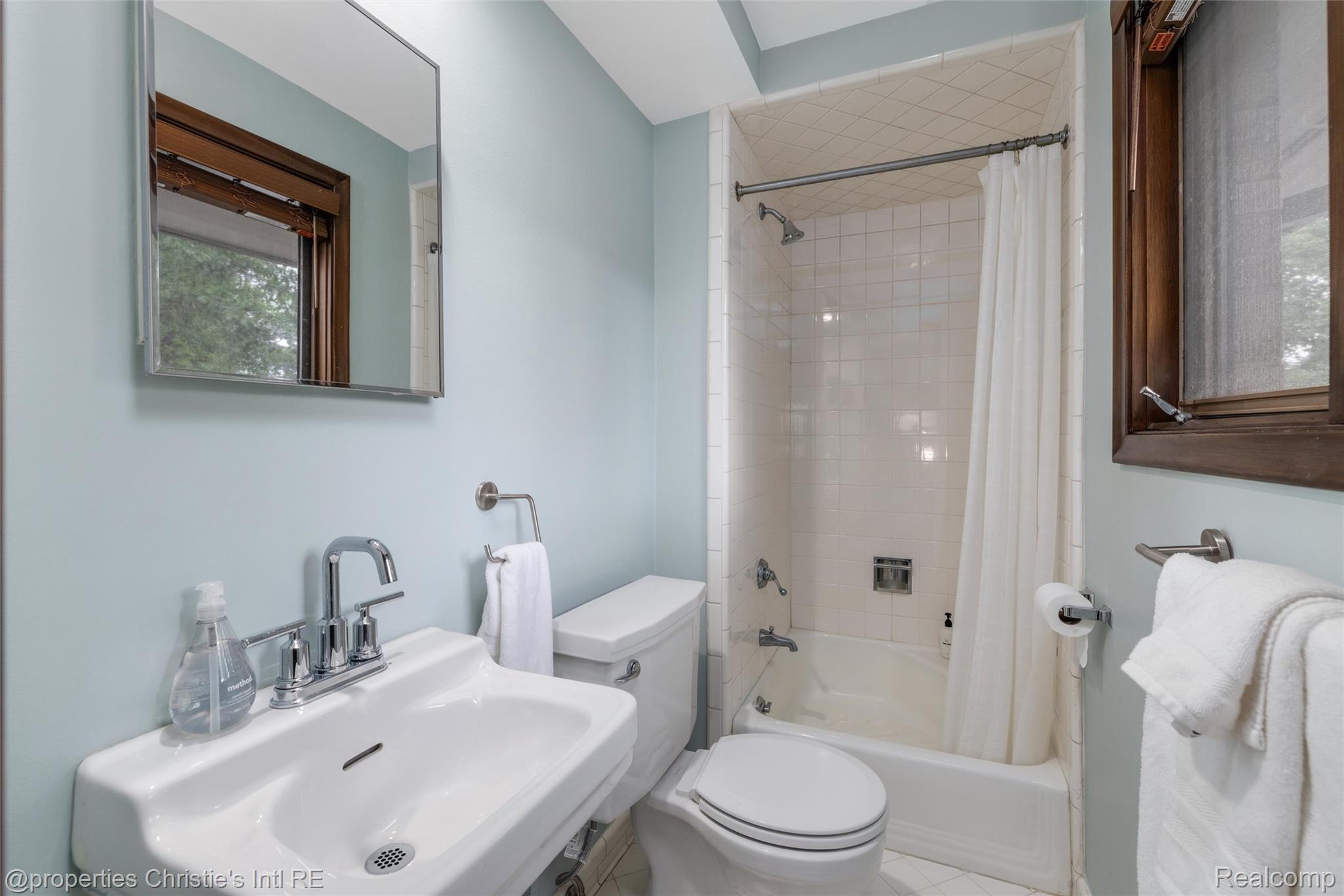 2771 West Seven Mile Road Detroit, MI 48221 - Photo 43 of 57 Bathroom featuring a white ceramic pedestal sink, chrome faucet, and a shower-over-tub combination with white subway tile surround