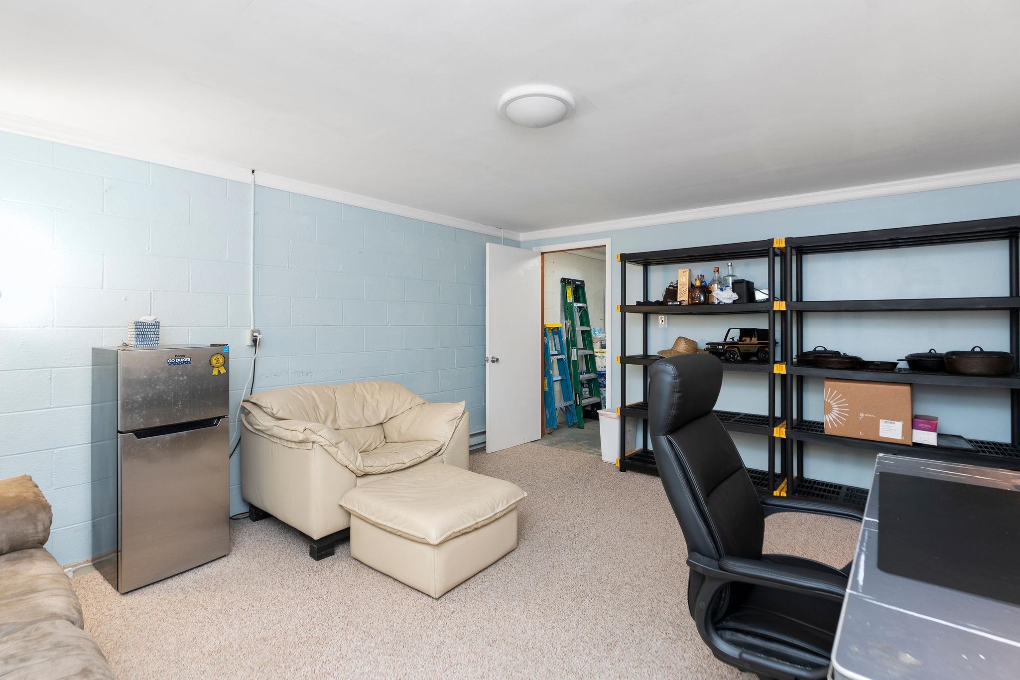 112 Country Lodge Road Waynesboro, VA 22980 - Photo 31 of 74 a living room with furniture and a book shelf