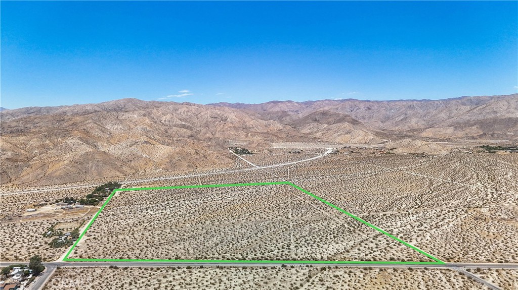 60 Dillon Road Desert Hot Springs, CA 92241 - Photo 1 of 35 a view of a field with a mountain in the background