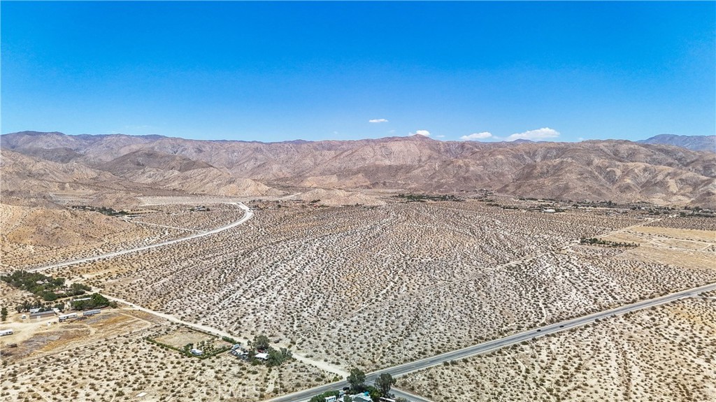 60 Dillon Road Desert Hot Springs, CA 92241 - Photo 9 of 35 a view of a dry yard with mountains in the background