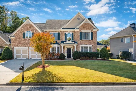 a front view of a house with a yard