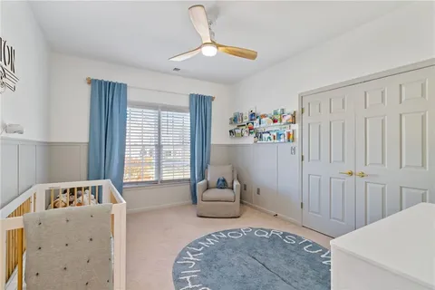 a spacious bedroom with a bed and a large window