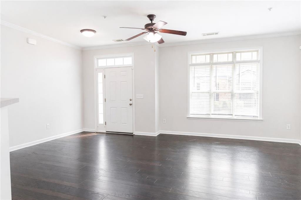544 Ridge View Crossing Woodstock, GA 30188 - Photo 5 of 41 a view of an empty room with wooden floor and a window