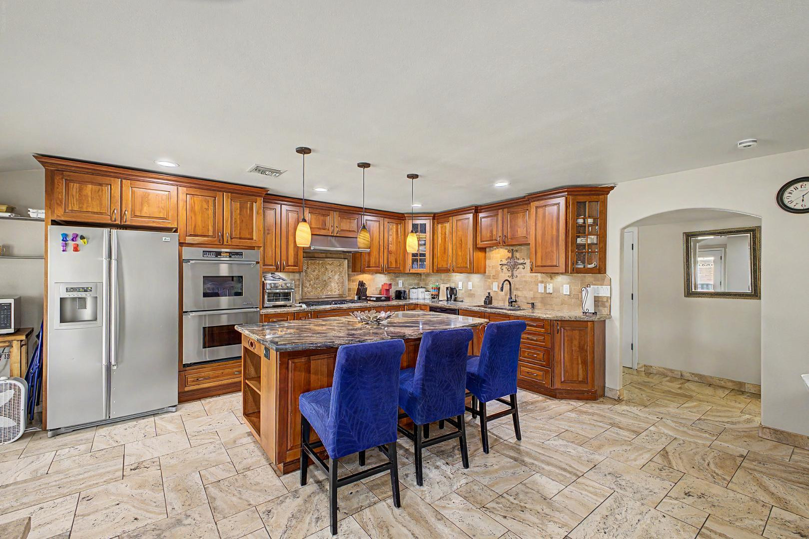 3346 East Cochise Road Phoenix, AZ 85028 - Photo 12 of 40 a kitchen with stainless steel appliances granite countertop a table chairs sink refrigerator and granite counter top