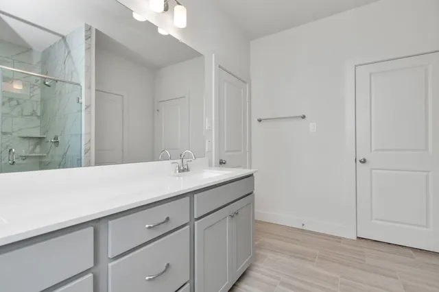 a bathroom with a sink double vanity and a mirror