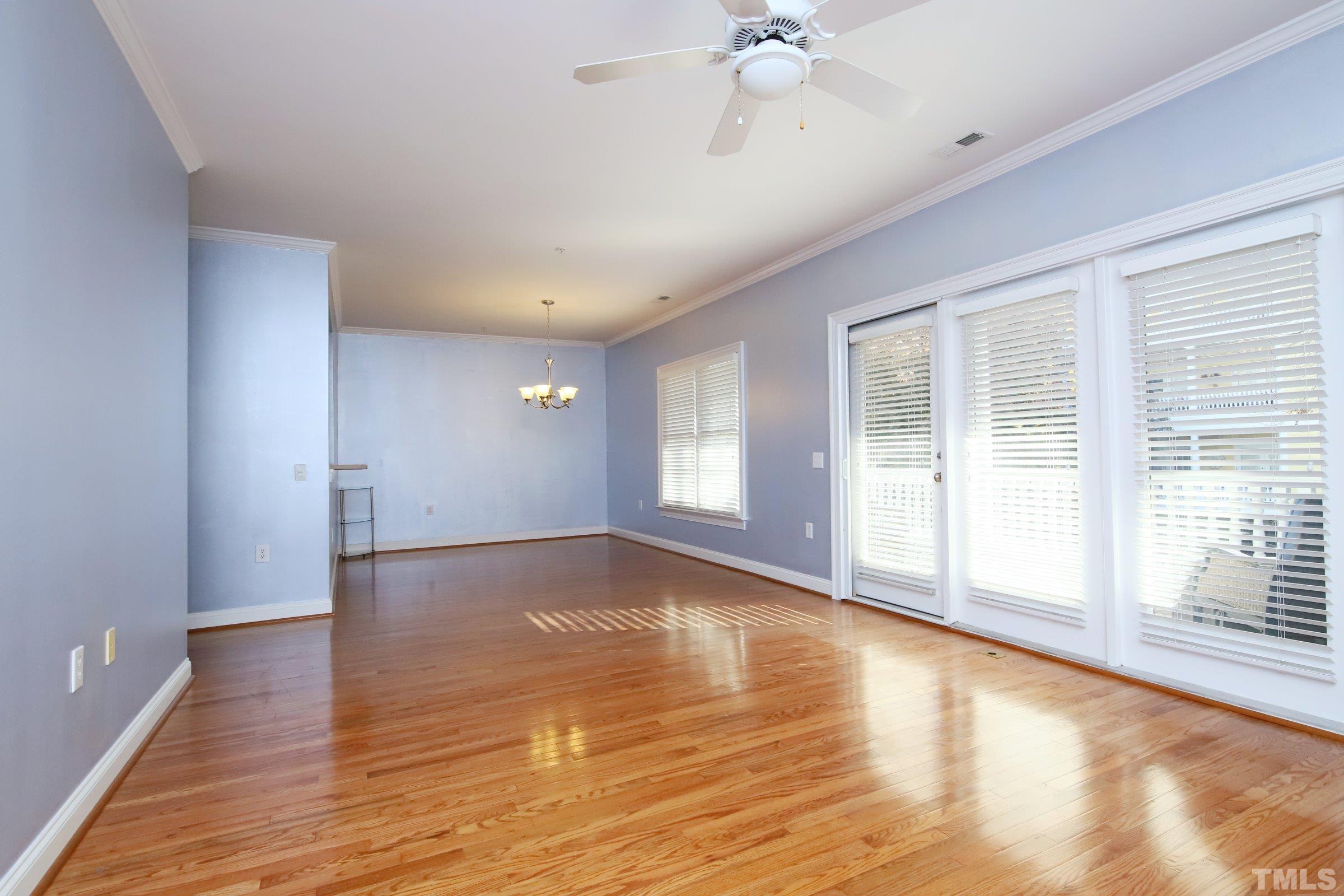 7530 Lead Mine Road, Unit 100 Raleigh, NC 27615 - Photo 14 of 26 a view of an empty room with wooden floor and a window