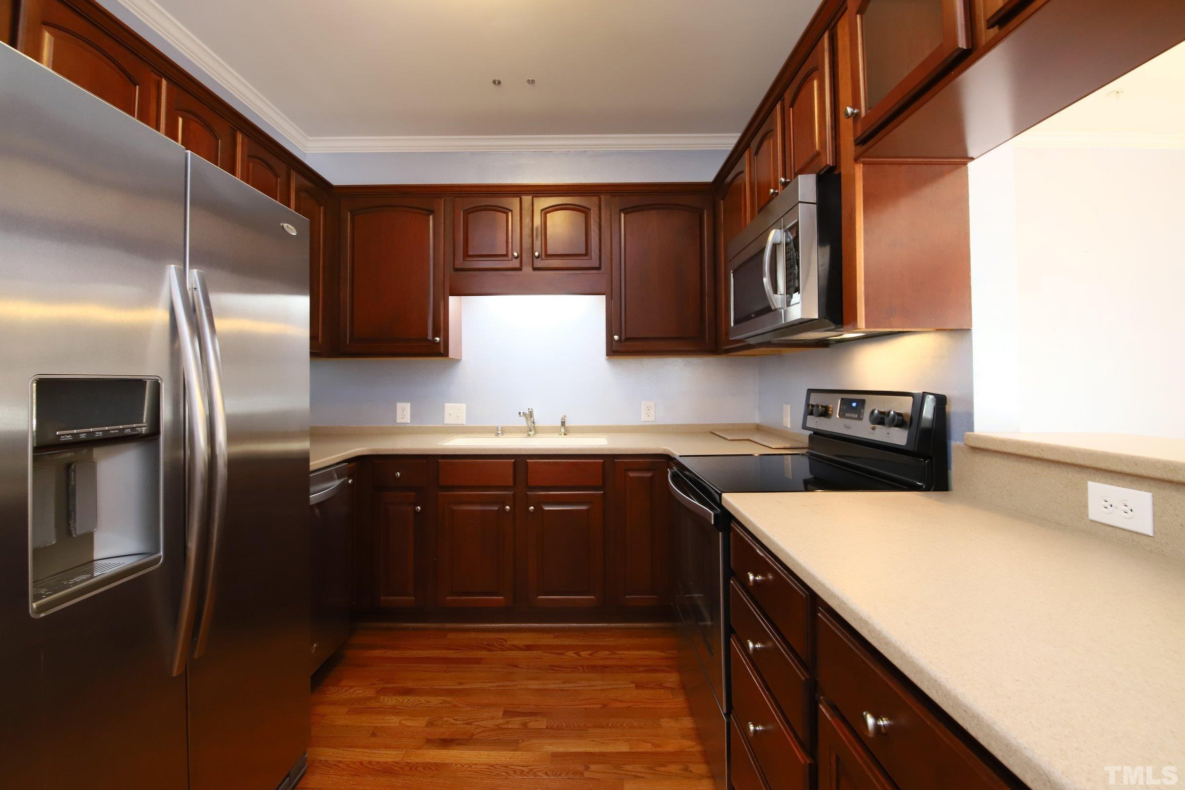 7530 Lead Mine Road, Unit 100 Raleigh, NC 27615 - Photo 8 of 26 a kitchen with stainless steel appliances granite countertop a refrigerator a stove and a sink