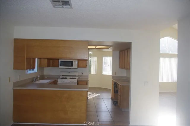 a kitchen with stainless steel appliances a stove a sink and a microwave