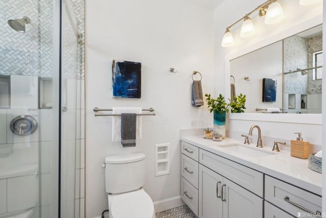 a bathroom with a toilet a sink and mirror