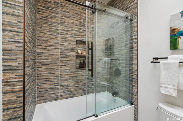 a view of a backyard with plants and large tree