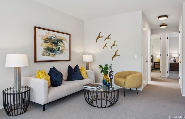 a living room with furniture and a painting