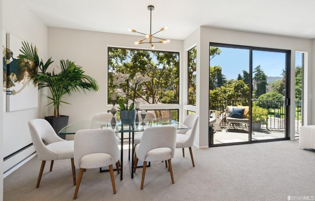 a view of a livingroom with furniture and floor to ceiling window