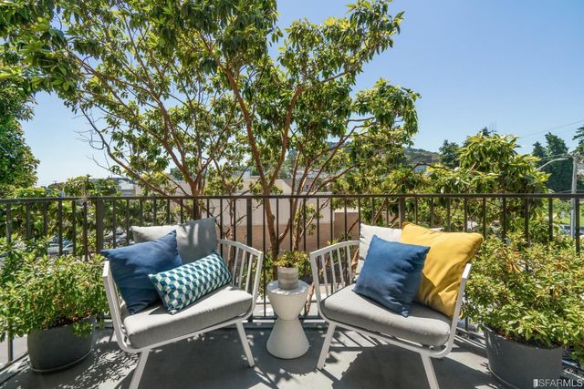 a balcony with furniture and a potted plant