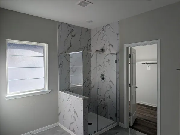 a bathroom with a bathtub and shower