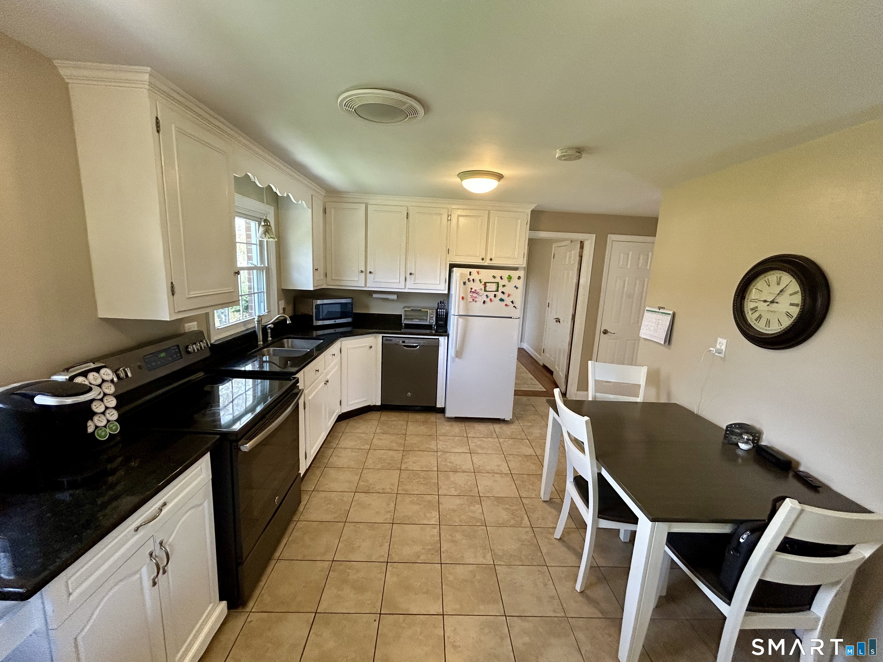 30 Apter Drive Torrington, CT 06790 - Photo 11 of 36 a kitchen with a table chairs and a refrigerator