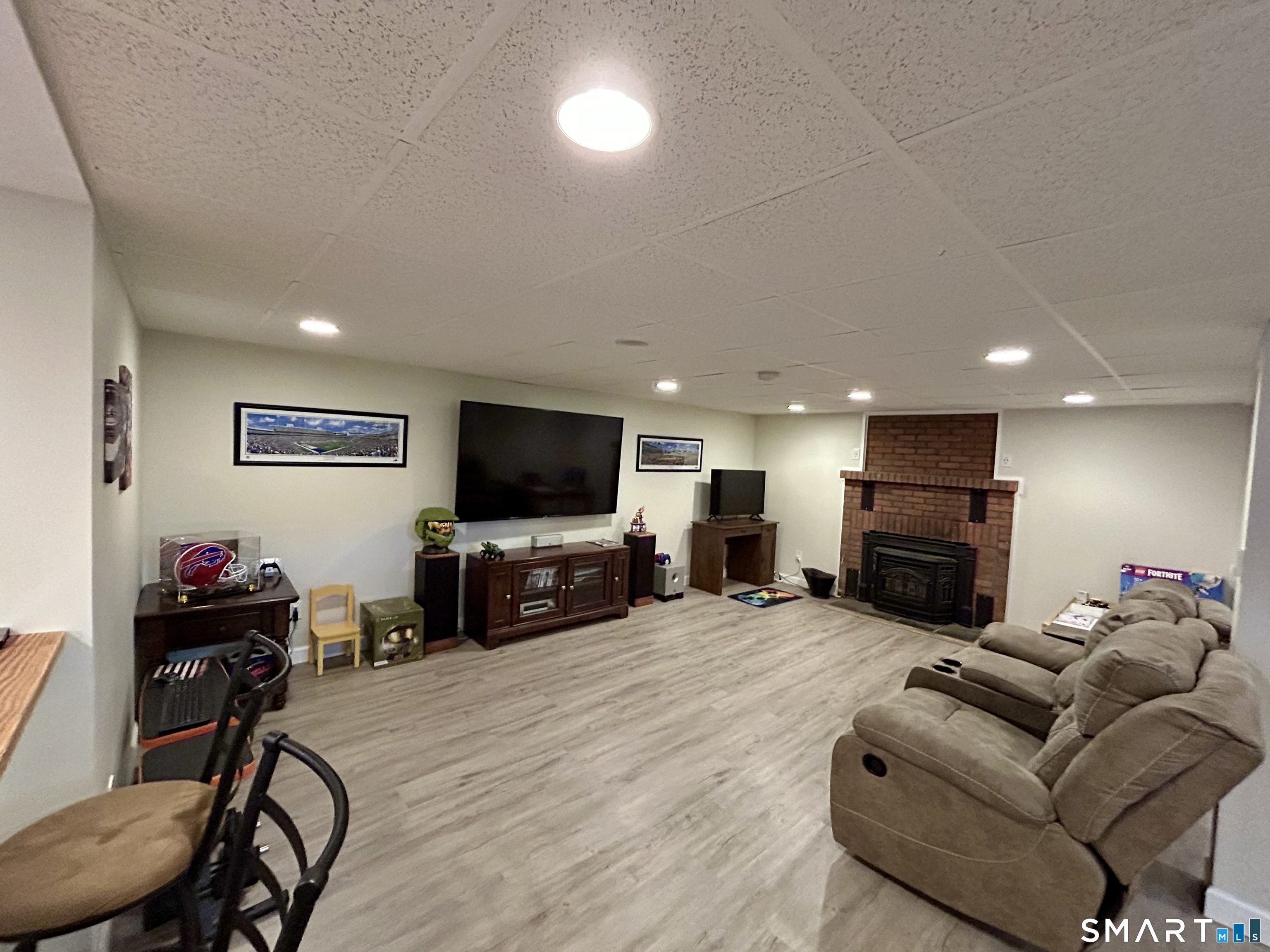 30 Apter Drive Torrington, CT 06790 - Photo 20 of 36 a living room with furniture a flat screen tv and a fireplace