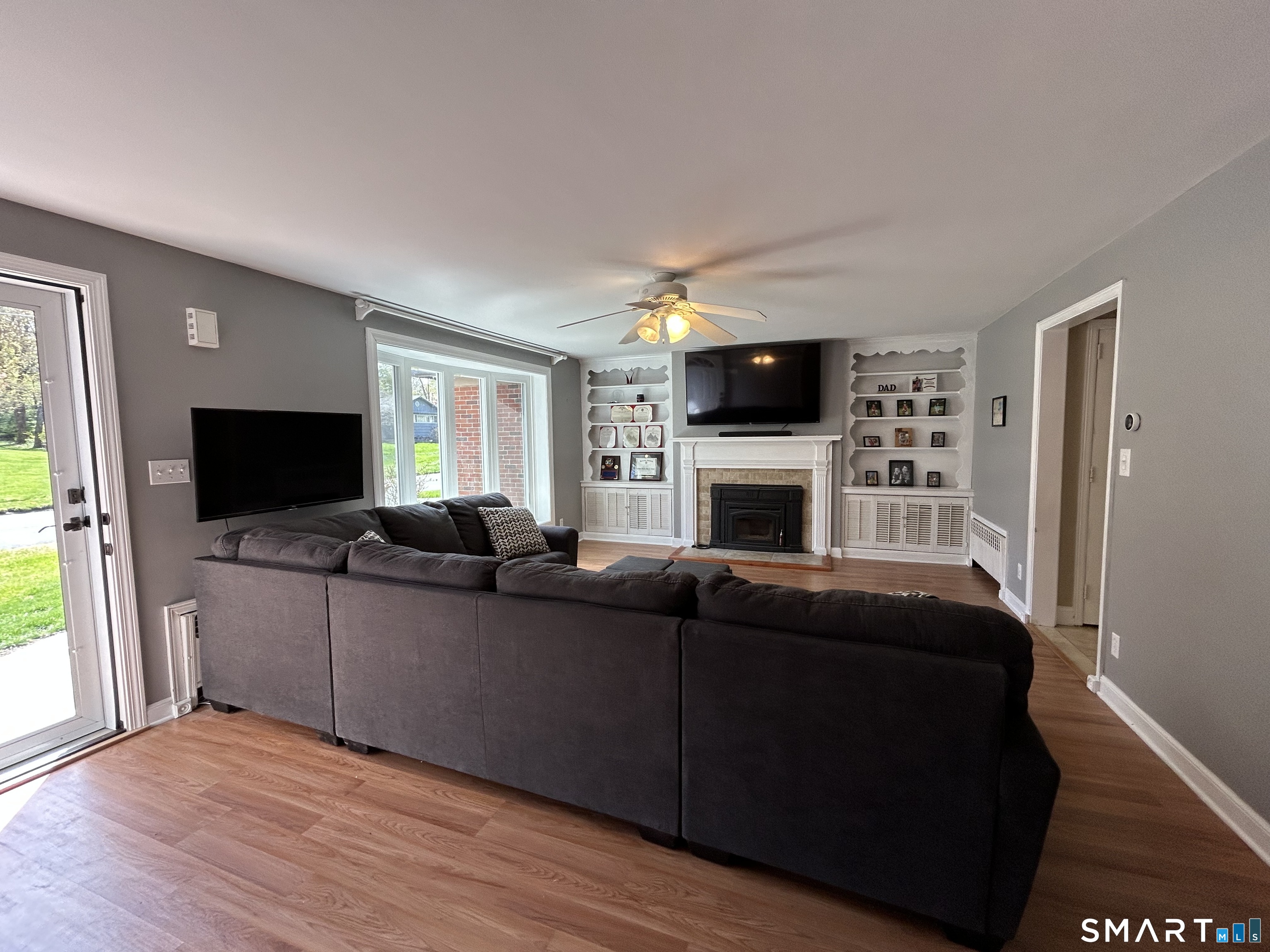 30 Apter Drive Torrington, CT 06790 - Photo 10 of 36 a living room with furniture a flat screen tv and a fireplace