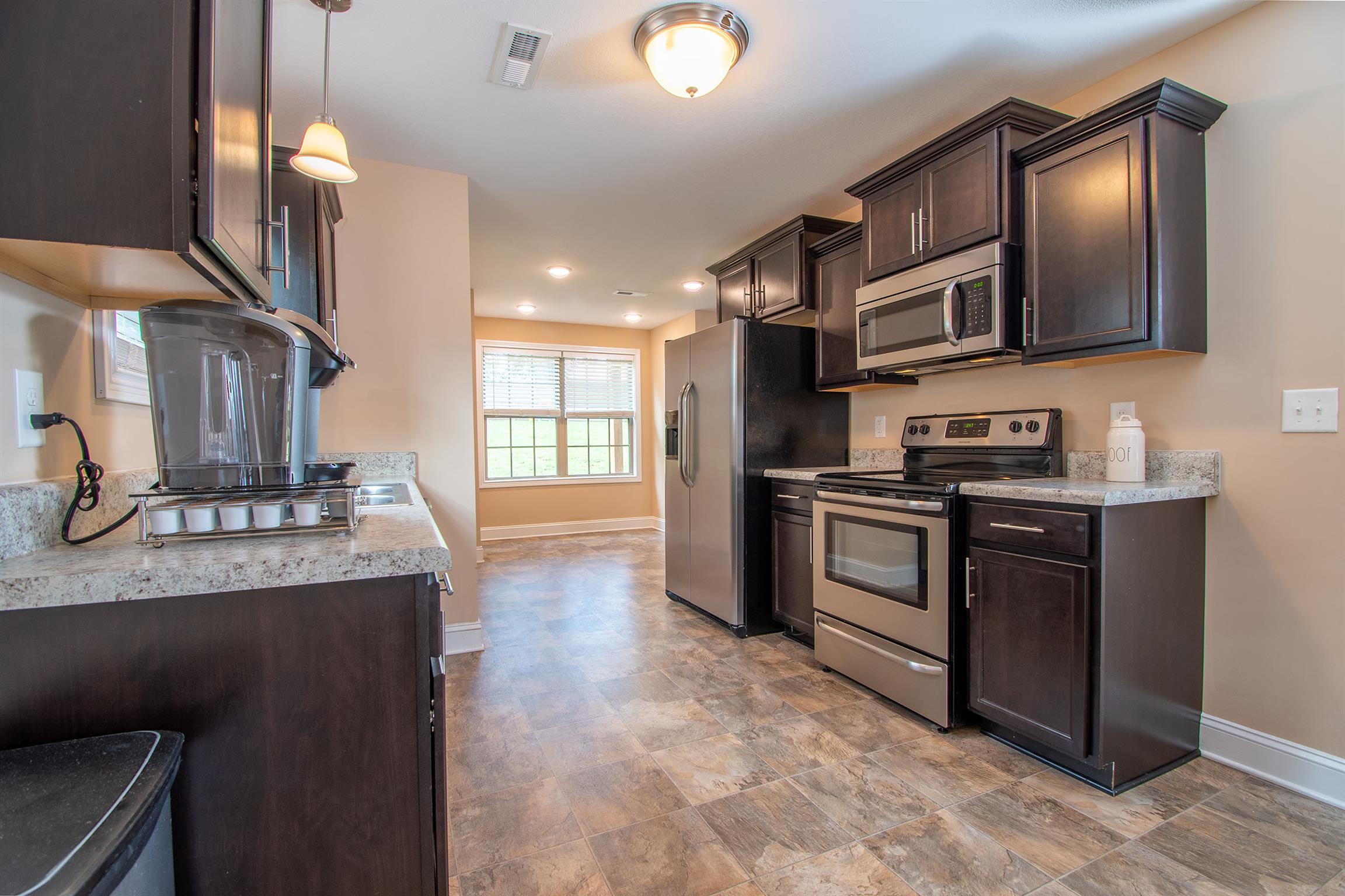 737 Inver Lane Clarksville, TN 37042 - Photo 4 of 17 a kitchen with stainless steel appliances granite countertop a stove and a sink