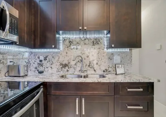 a kitchen with a sink and cabinets