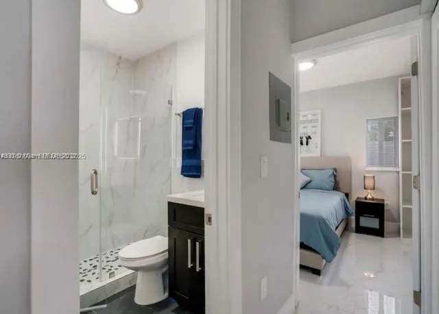 a bedroom with a bed and a view of bathroom