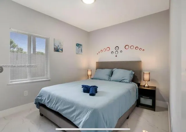 a bedroom with a bed and window