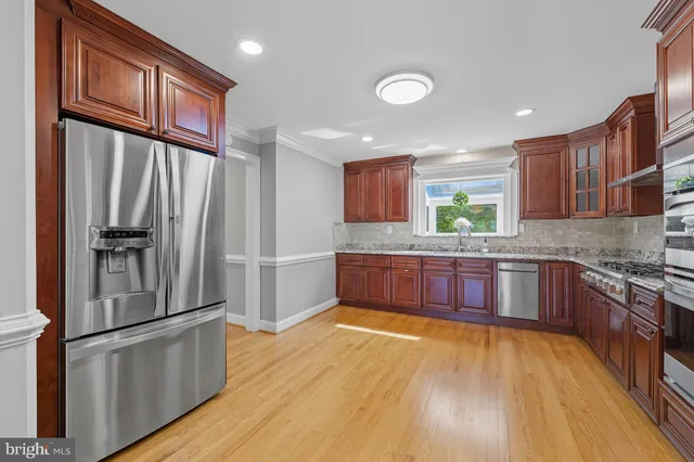 a kitchen with stainless steel appliances granite countertop a sink and cabinets