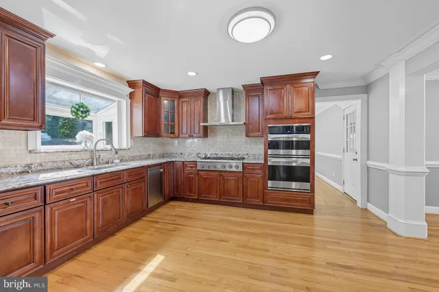 a kitchen with stainless steel appliances granite countertop a refrigerator and a sink
