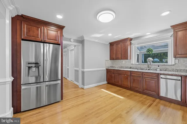 a view of an empty room with a window and a fireplace