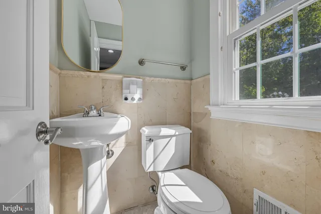 a view of a hallway with wooden floor and stairs