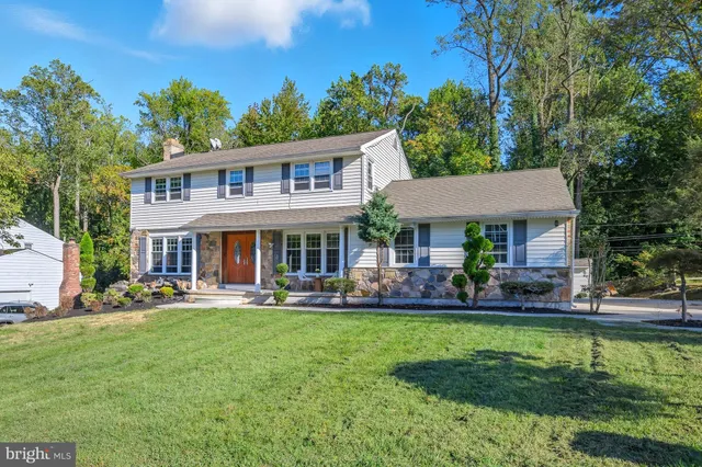 a front view of a house with a yard table and chairs