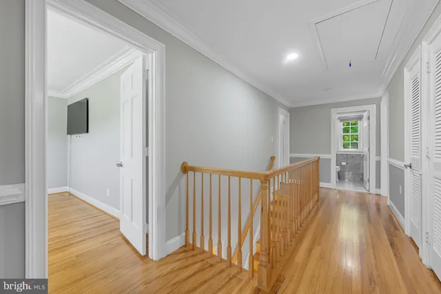 a kitchen with a dining table chairs stainless steel appliances and cabinets