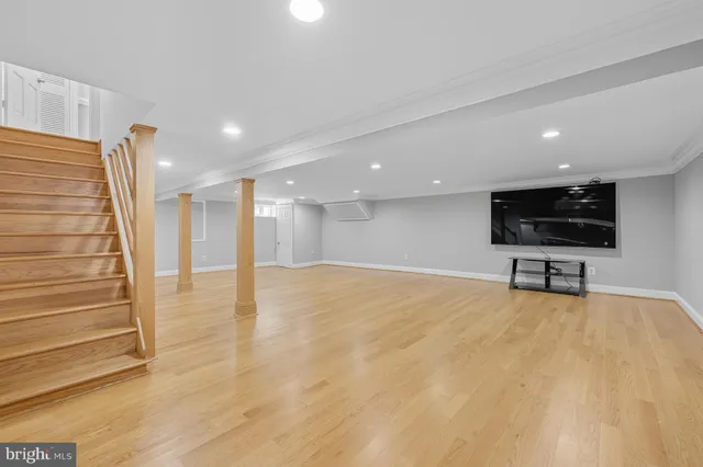 a living room with dining room and wooden floor